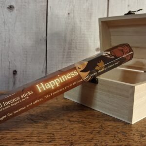 A tube of incense sticks with package designed by Lisa Parker. Package is brown, black and cream with face of a witch in front of a full moon and bare tree