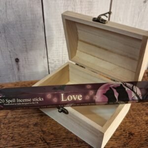 A tube of incense sticks in a package designed by Lisa Parker. The package is mulberry,black and cream in collow with 2 cats in front of a full mon and bare tree