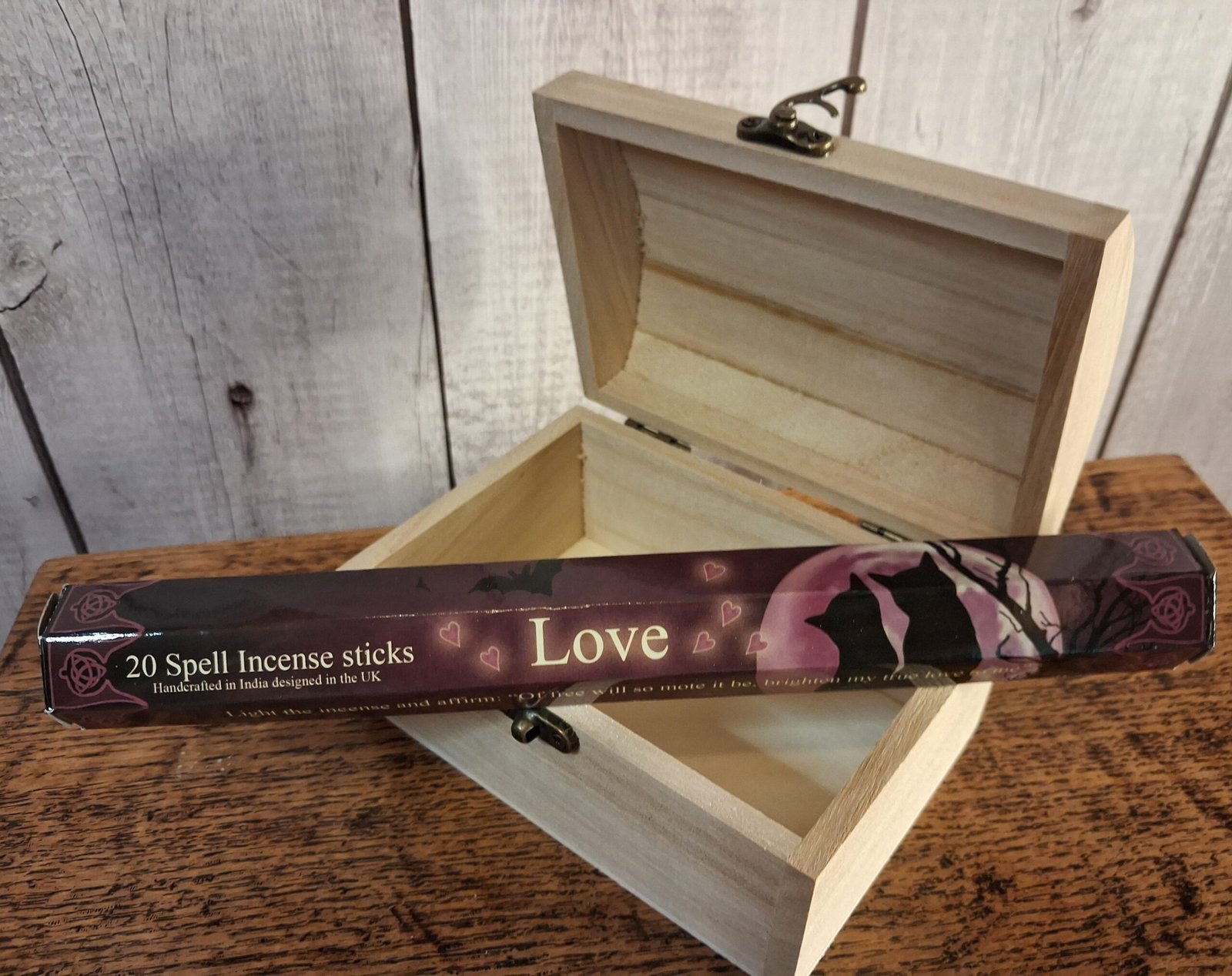 Elements Love Incense Sticks by Lisa Parker 1 A tube of incense sticks in a package designed by Lisa Parker. The package is mulberry,black and cream in collow with 2 cats in front of a full mon and bare tree