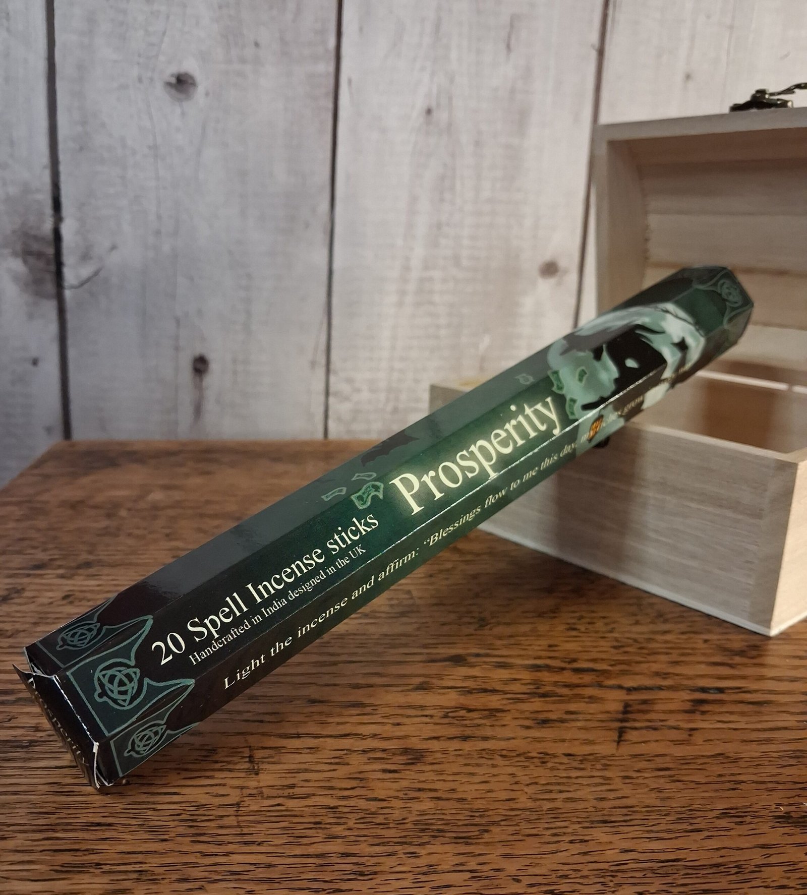 Elements Prosperity Incense Sticks 1 Tube containing incense sticks. Decorated by Lisa Parker that is green, black and cream with a witch flying on a broom and a full moon behind her along with bare tree