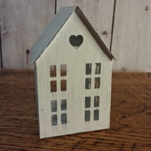 Whitewashed tin rustic house with window cut outs with opening in back for a tea light