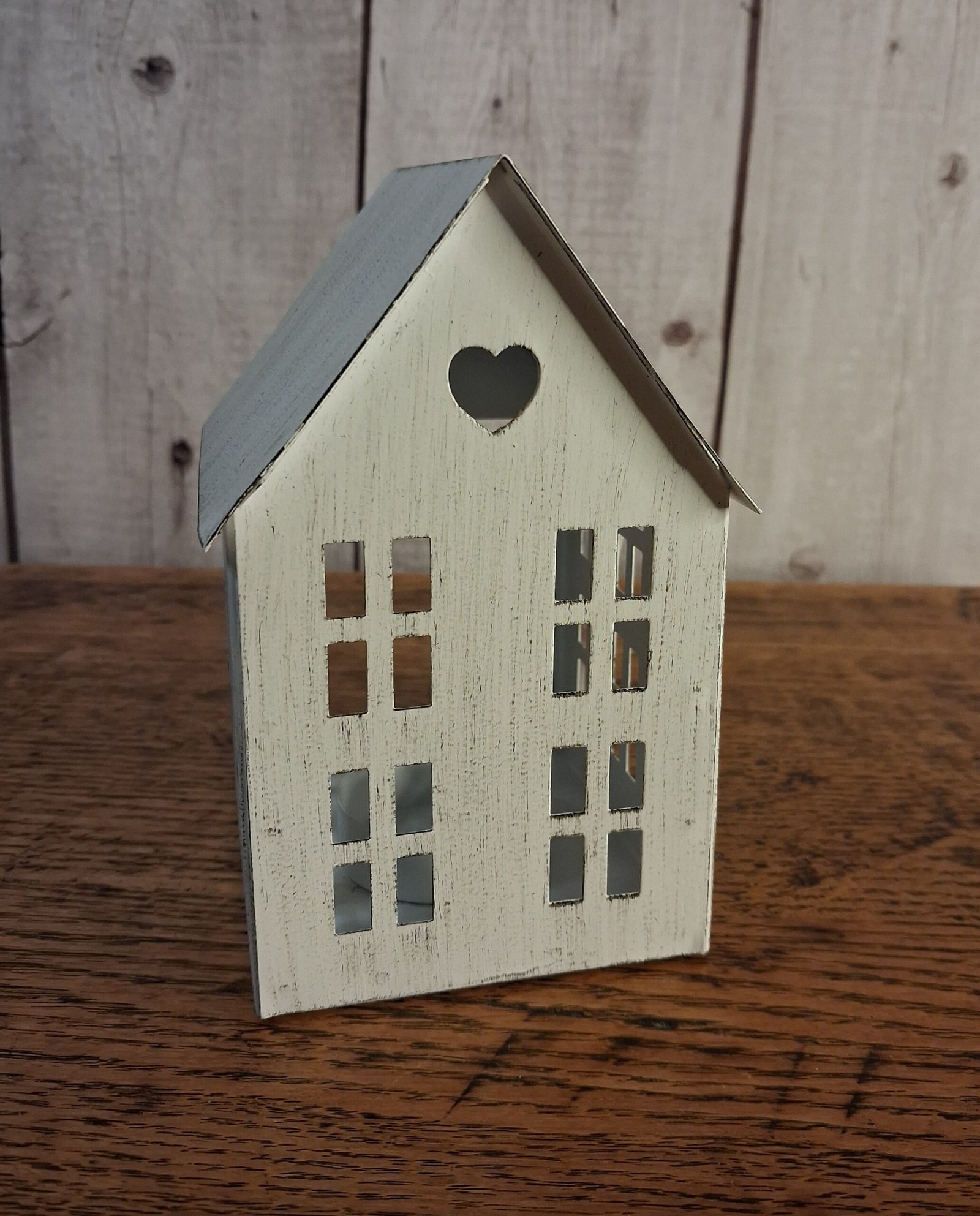 Rustic T-Light House, 13cm 1 Whitewashed tin rustic house with window cut outs with opening in back for a tea light