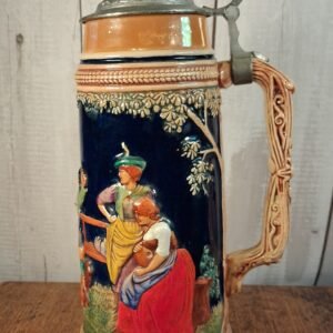 A stein ceramic and pewter with a scene is traditional of rural life scenes in the local pub or tavern
