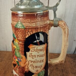 A stein of ceramic and pewter depicting mounted Nobleman happening upon 3 armed robbers/highwaymen with 1 trying to escape through a window.