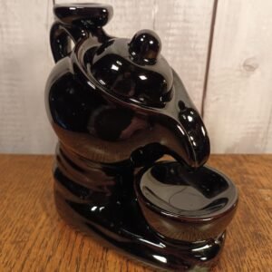 A black ceramic backflow incense burner with an eye-catching teapot and cup design