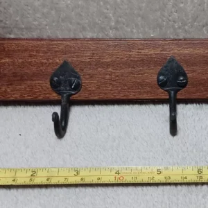 Anpiece of upcycled mahogany from a ripped out conservatory. Hooks are handforged from a small blacksmith business